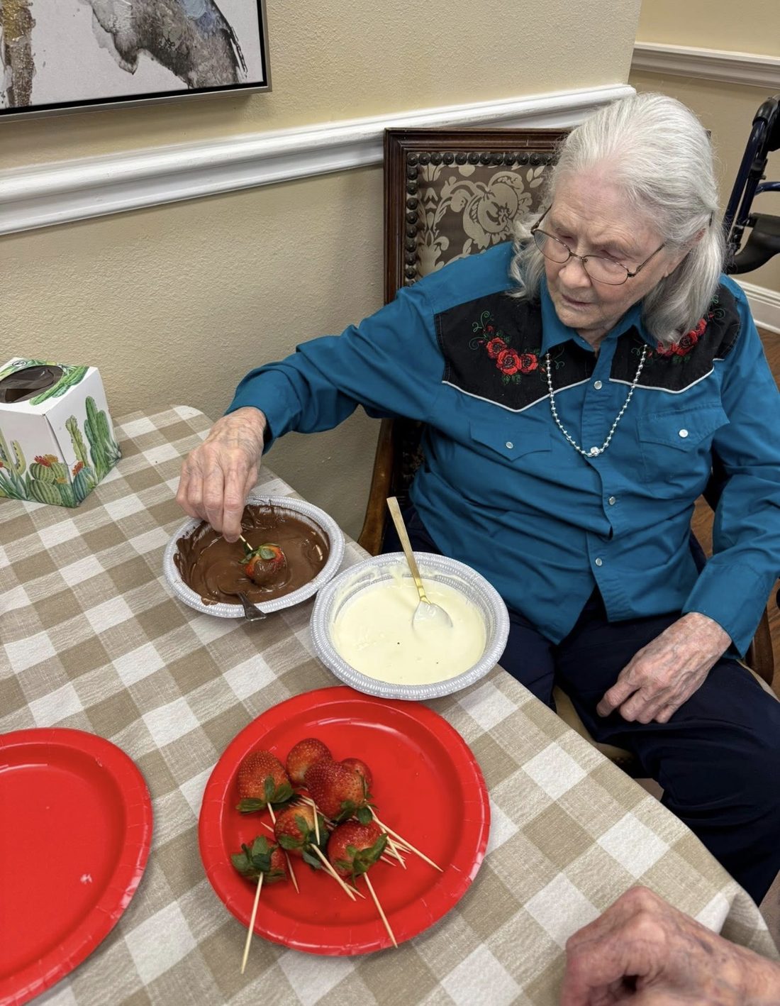 Resident dipping chocolate-covered strawberries
