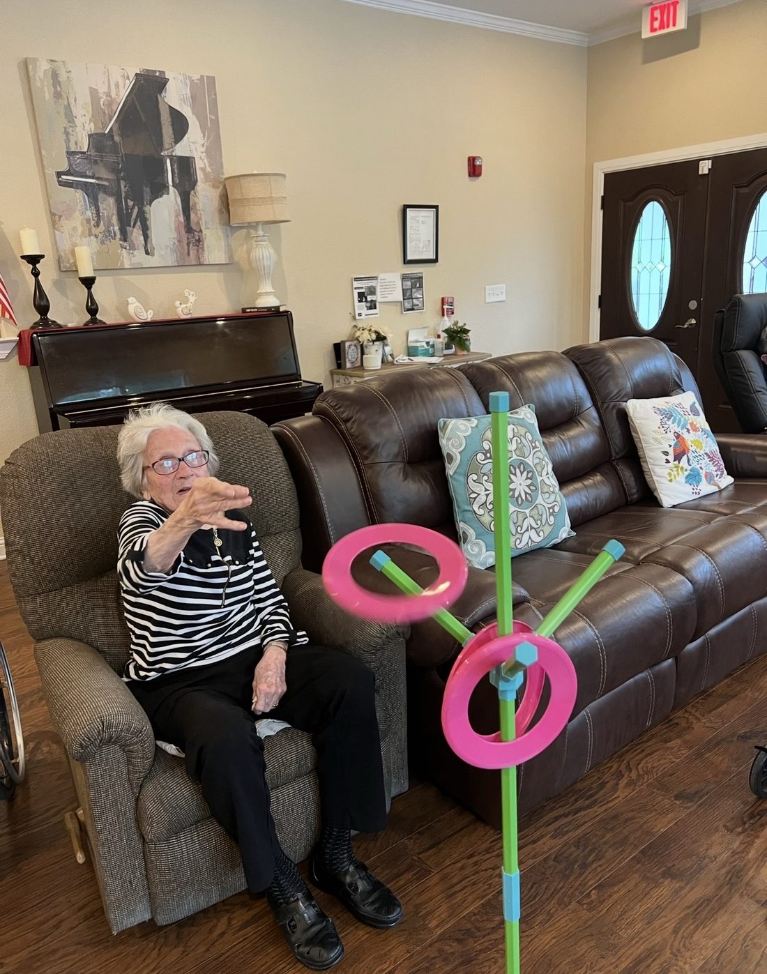 Resident playing a ring toss game